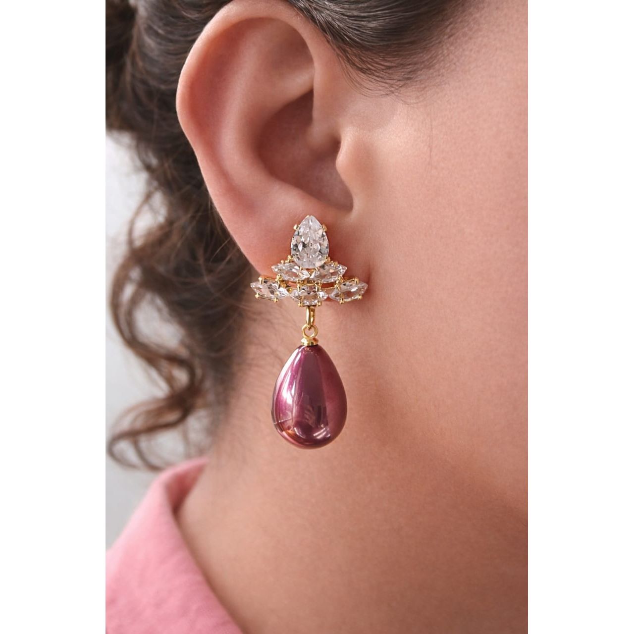 Plum rose teardrop crystal earrings worn on model with gold-tone crystal cluster, reflective finish