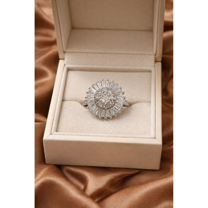 Silver halo statement ring with central round crystal and baguette halo displayed in luxury jewelry box on satin fabric