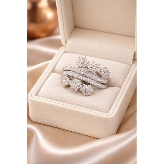 Silver floral cluster pavé wrap ring displayed in beige luxury jewelry box with satin background