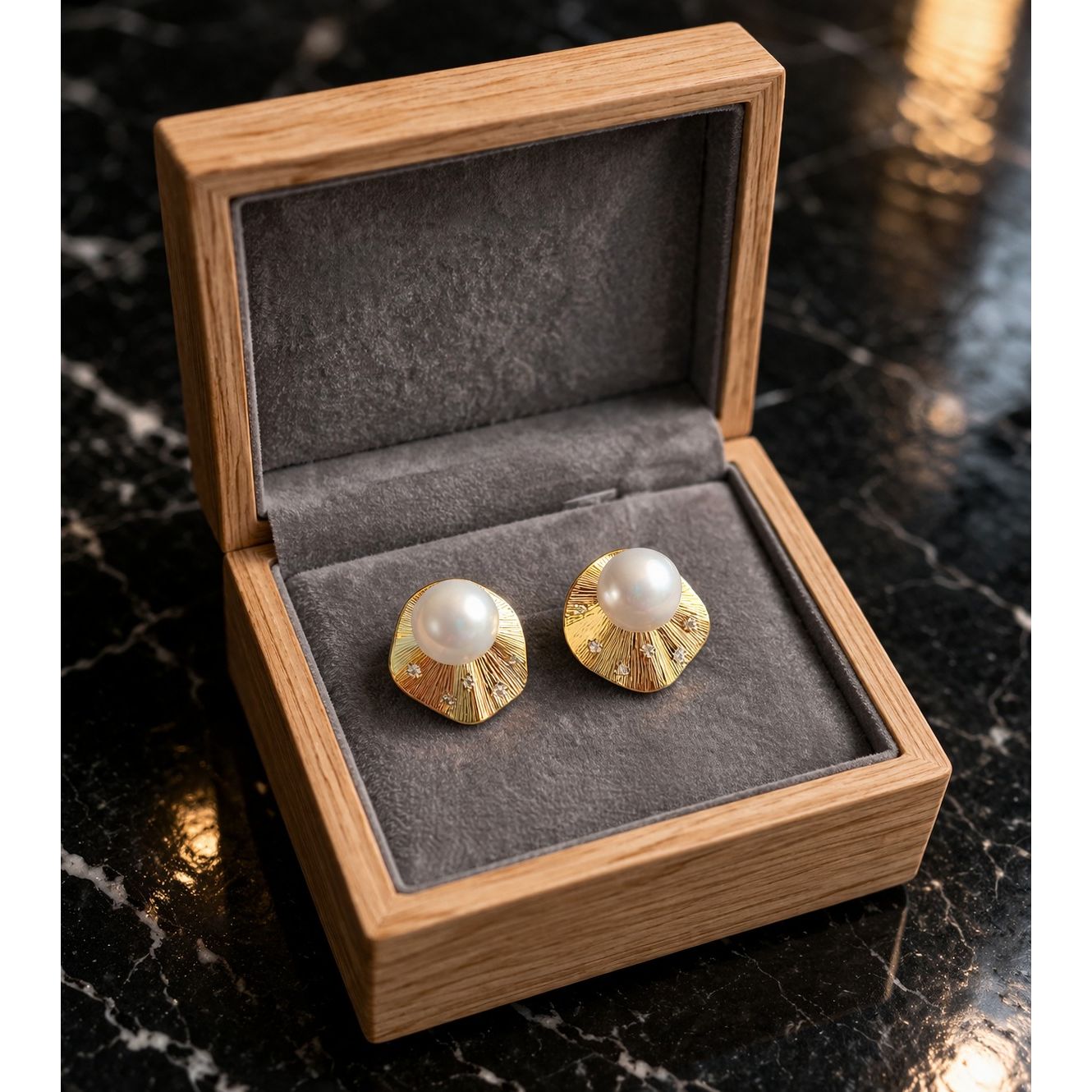Gold textured pearl stud earrings displayed in wooden velvet jewelry box 