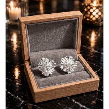 Silver floral stud earrings displayed in wooden velvet jewelry box 