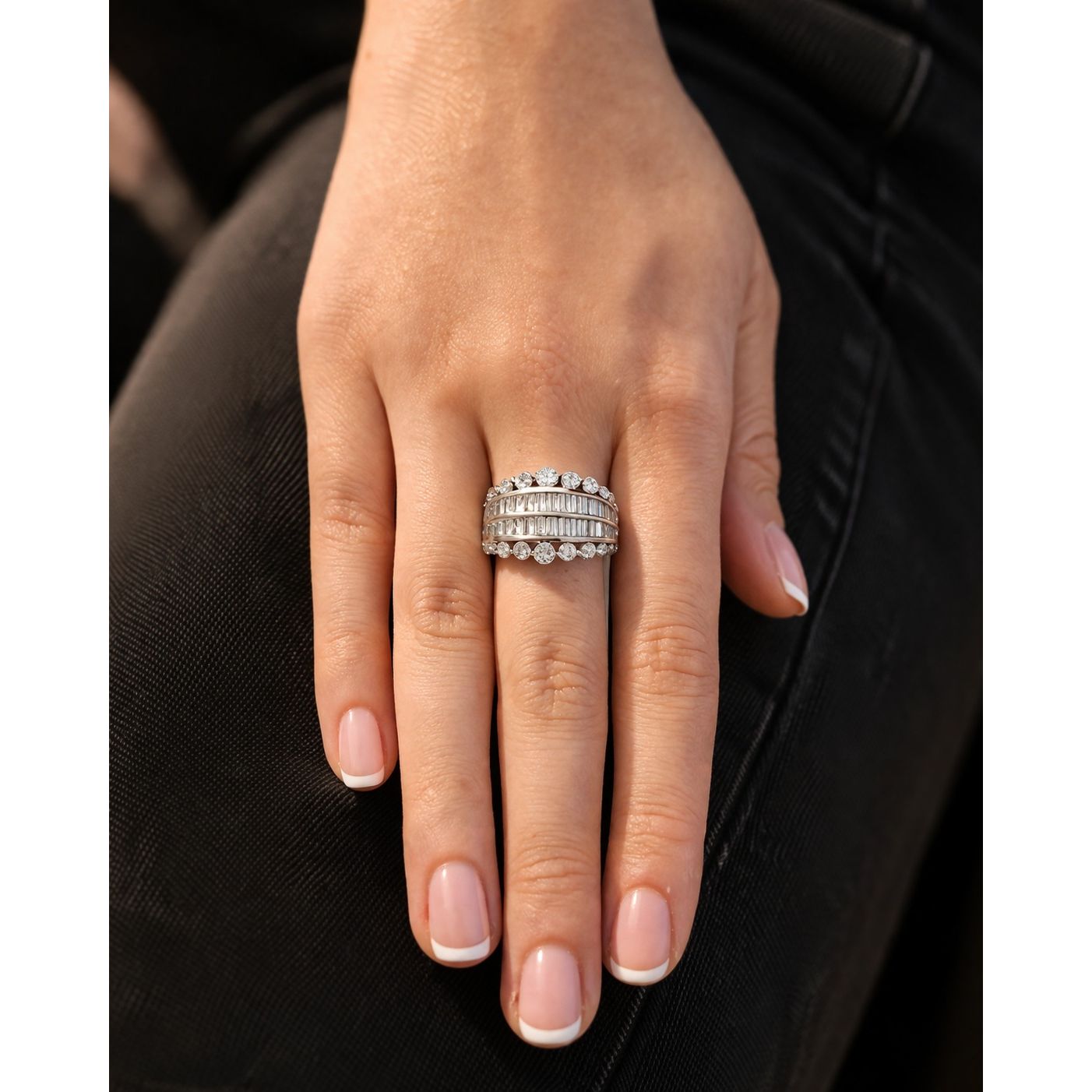 Silver adjustable multi row crystal band ring with baguette and round stones worn on hand