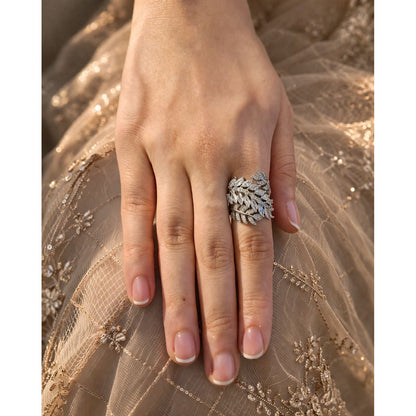Silver leaf design statement ring with marquise crystals worn on hand with embroidered fabric background