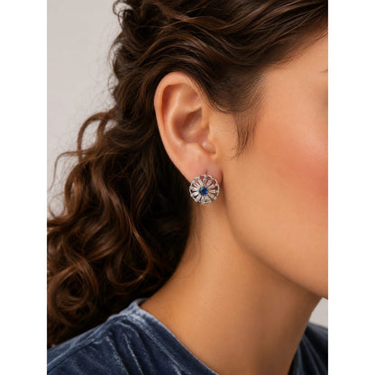 Silver stud earrings with blue center worn on ear side profile