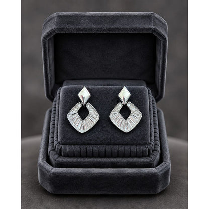 Silver geometric crystal earrings displayed in a premium charcoal velvet jewelry box with elegant studio presentation.