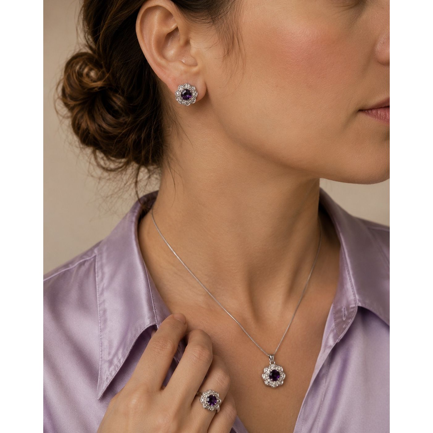 Model wearing a royal amethyst floral halo jewelry set with matching stud earrings, pendant necklace, and statement ring surrounded by crystal accents.