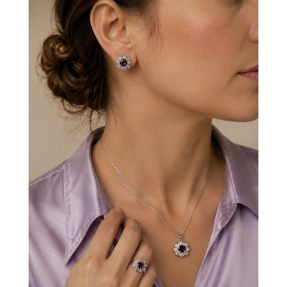 Model wearing a royal amethyst floral halo jewelry set with matching stud earrings, pendant necklace, and statement ring surrounded by crystal accents.