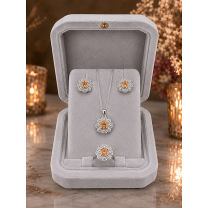 Champagne gold floral halo jewelry set displayed in a premium ivory velvet jewelry box featuring matching pendant, stud earrings, and ring.