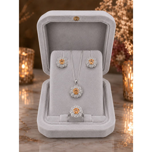 Champagne gold floral halo jewelry set displayed in a premium ivory velvet jewelry box featuring matching pendant, stud earrings, and ring.