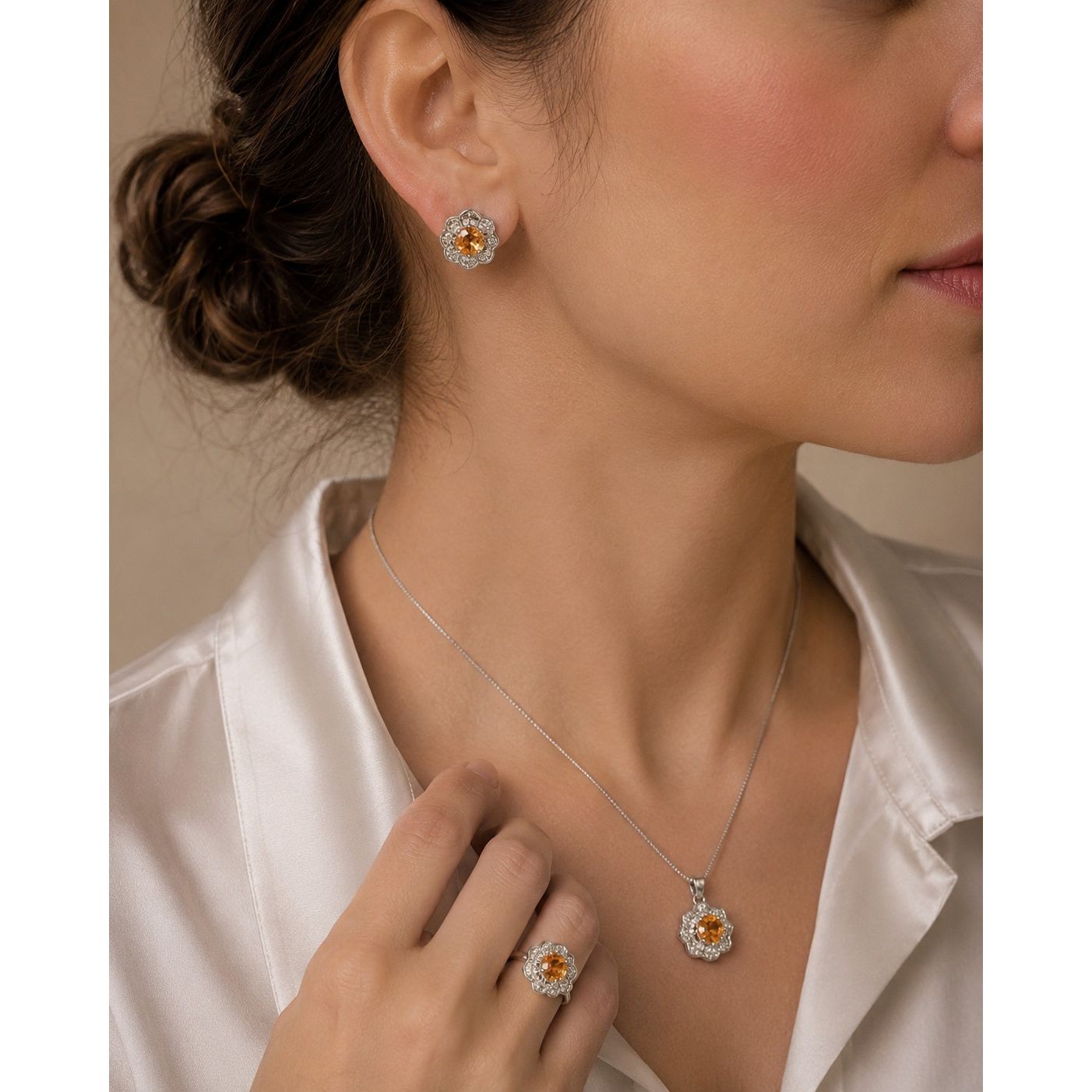 Model wearing a champagne gold floral halo jewelry set featuring matching stud earrings, pendant necklace, and statement ring with sparkling crystal accents.