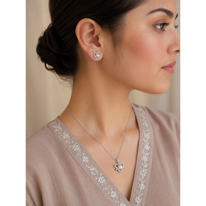 Model wearing a silver pearl blossom pendant necklace and matching floral stud earrings featuring pearl center stones and crystal accents.