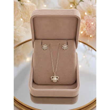 Pearl blossom necklace and matching stud earrings displayed in a premium blush beige velvet jewelry box with floral-inspired detailing.