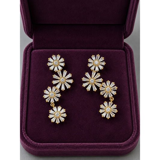 Gold Bloom Cascade floral cubic zirconia drop earrings displayed inside a premium plum velvet jewellery box.