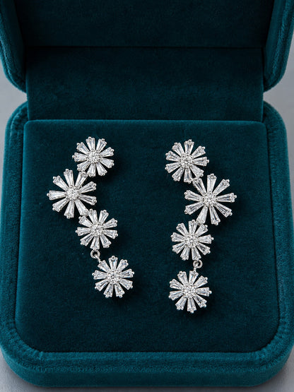 Silver Bloom Cascade floral cubic zirconia drop earrings displayed inside a premium deep teal velvet jewellery box.