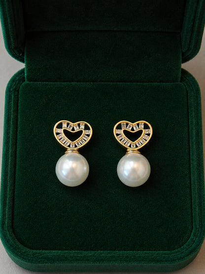 Gold heart pearl stud earrings with cubic zirconia displayed inside a premium emerald velvet jewellery box.