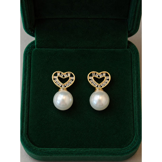 Gold heart pearl stud earrings with cubic zirconia displayed inside a premium emerald velvet jewellery box.