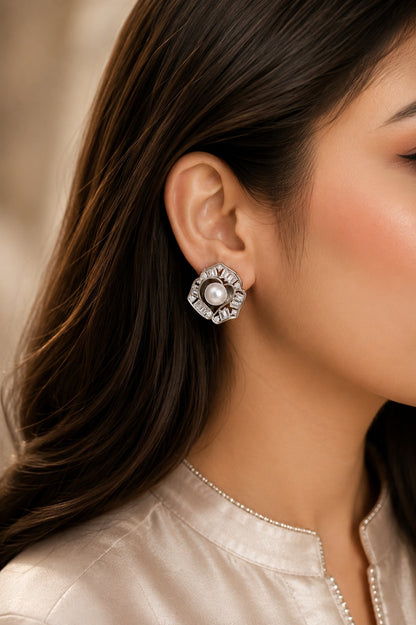 Model wearing silver-tone floral stud earrings with a pearl centre and baguette-cut crystals, perfect for bridal, festive, and formal styling