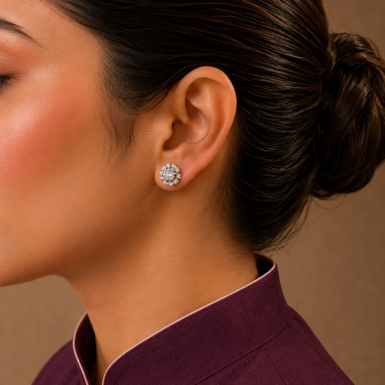 Silver crystal halo stud earrings worn on model, round sparkling cubic zirconia stud earrings with premium silver-tone finish.