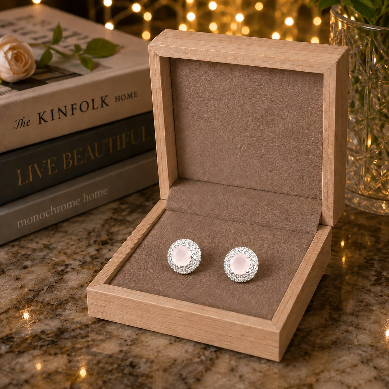 Blush pink halo gemstone crystal stud earrings displayed in a premium taupe velvet jewelry box.