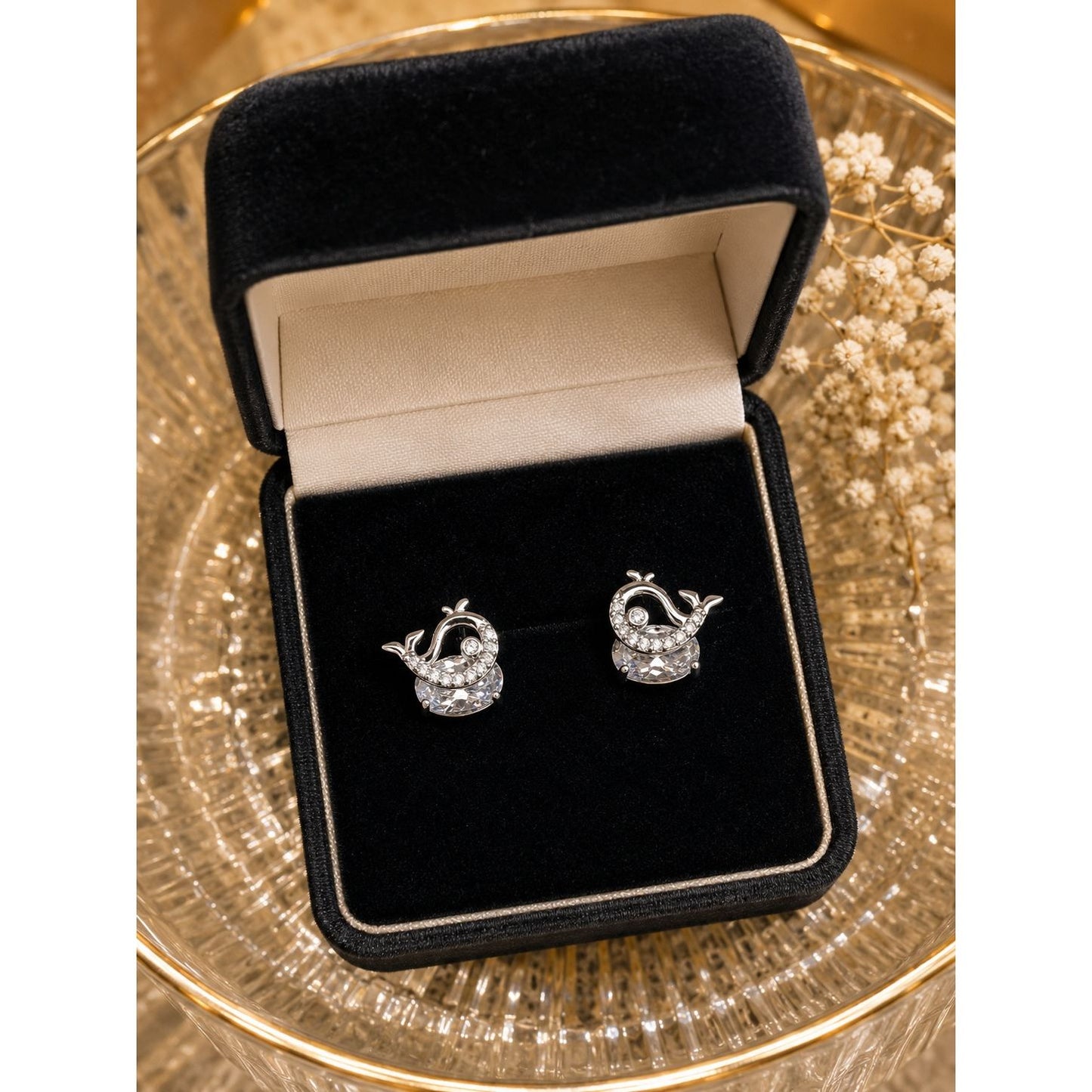 Silver whale stud earrings with cubic zirconia and round crystal displayed in a premium black velvet jewelry box.