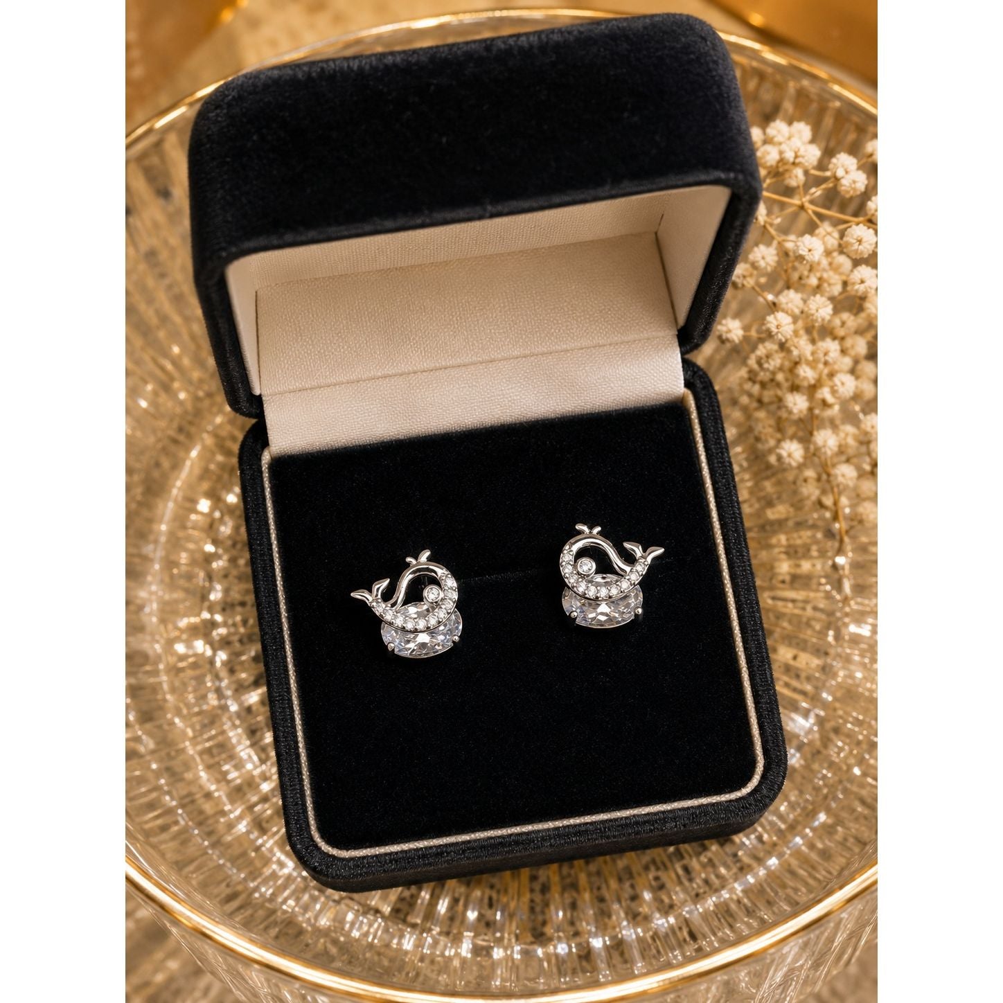 Silver whale stud earrings with cubic zirconia and round crystal displayed in a premium black velvet jewelry box.