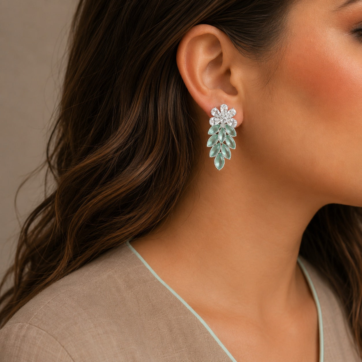 Close-up of a woman wearing a floral earring with a neutral background