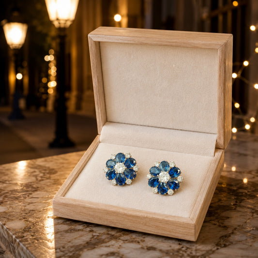 Royal blue floral crystal stud earrings displayed in a premium wooden jewelry box with elegant styling.