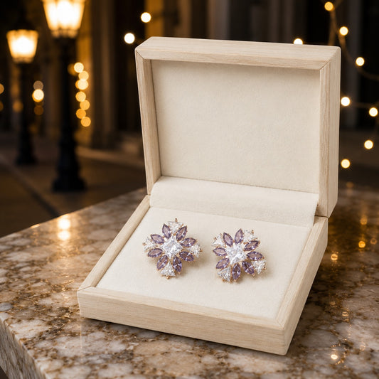 Lavender starburst crystal stud earrings displayed in a premium wooden jewelry box with elegant marble and evening-inspired styling.