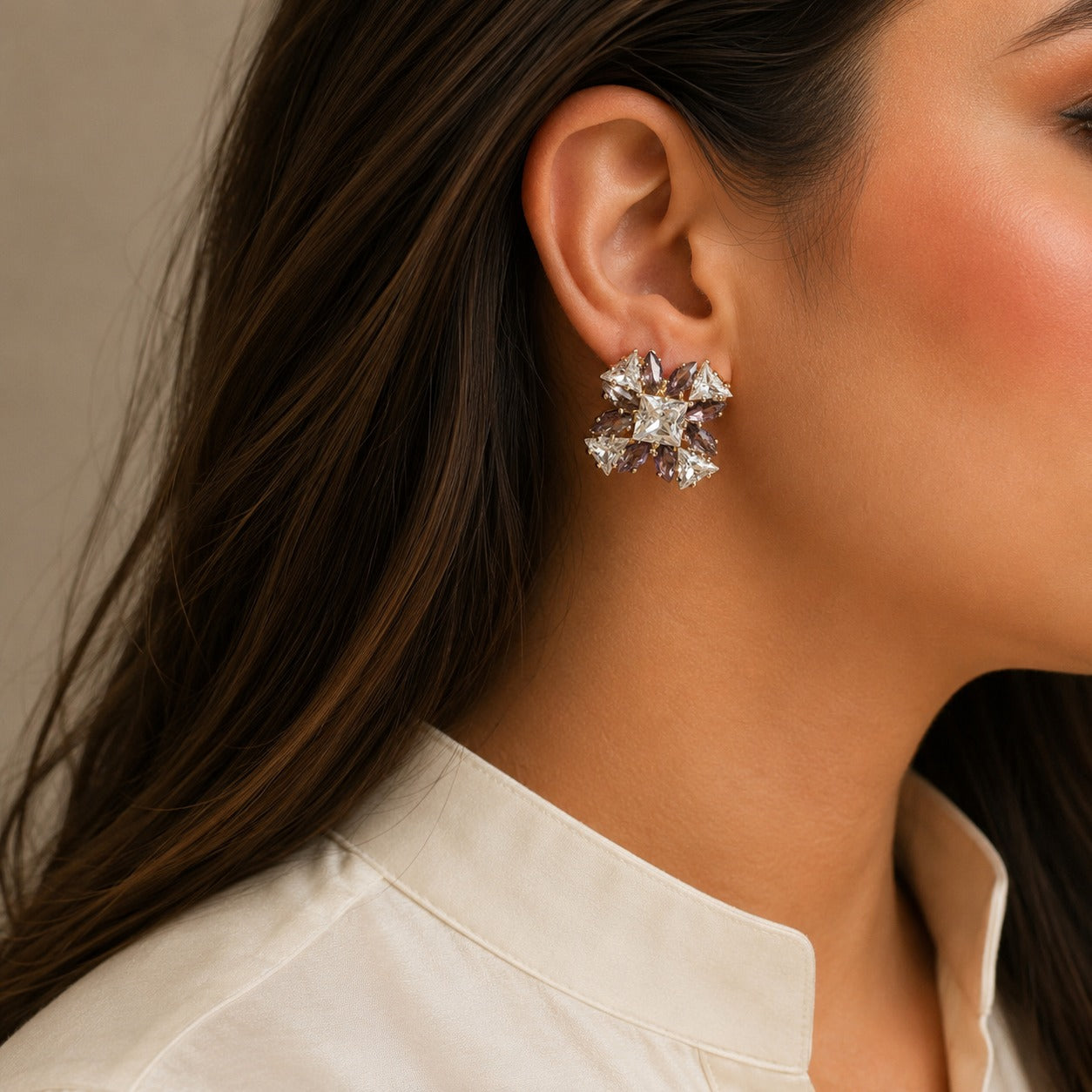 Woman wearing premium lavender starburst crystal stud earrings with princess-cut center stone and marquise crystal accents in a luxury side-profile portrait.