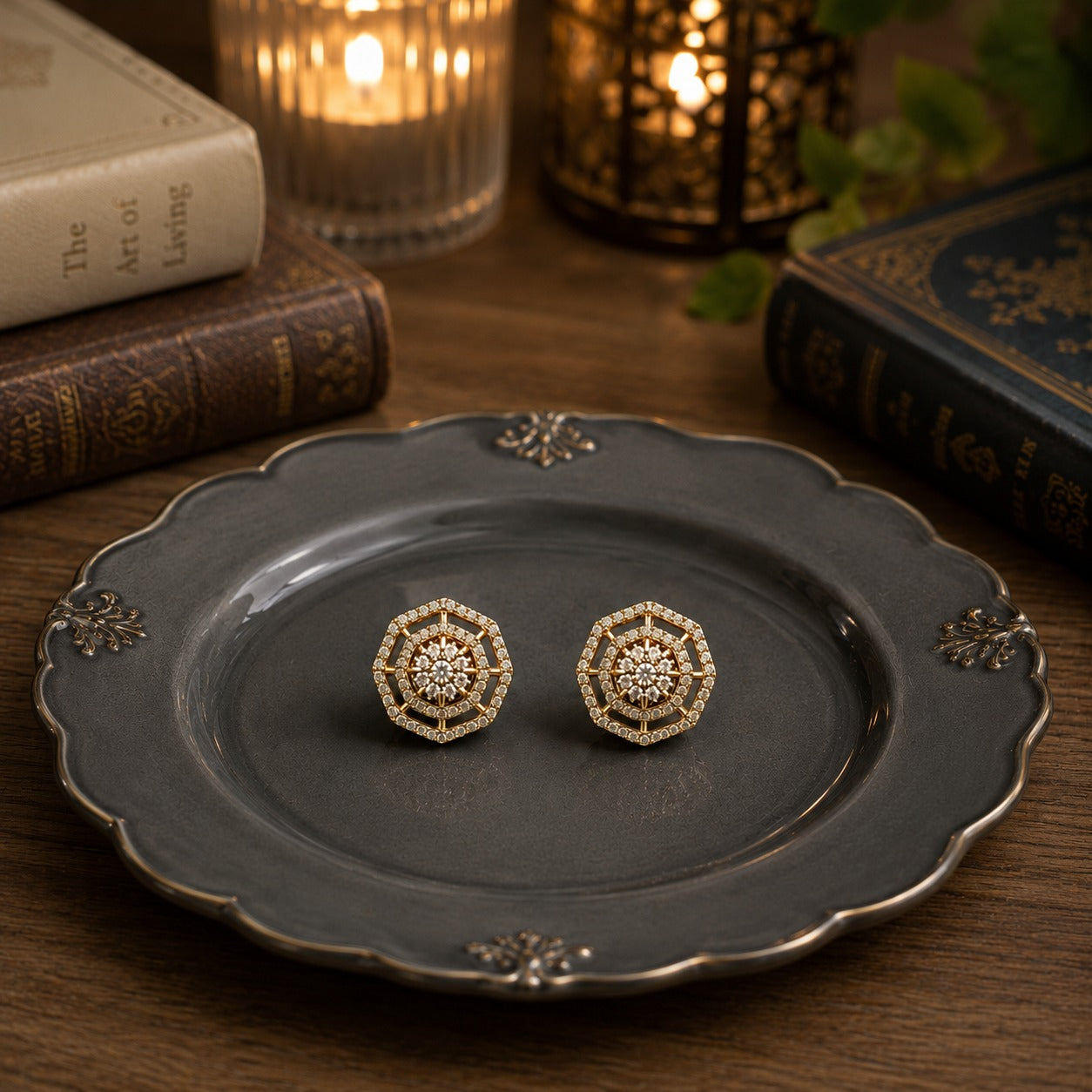 Geometric halo crystal stud earrings displayed on a premium charcoal grey ceramic plate with vintage books, candlelight, and lantern décor.