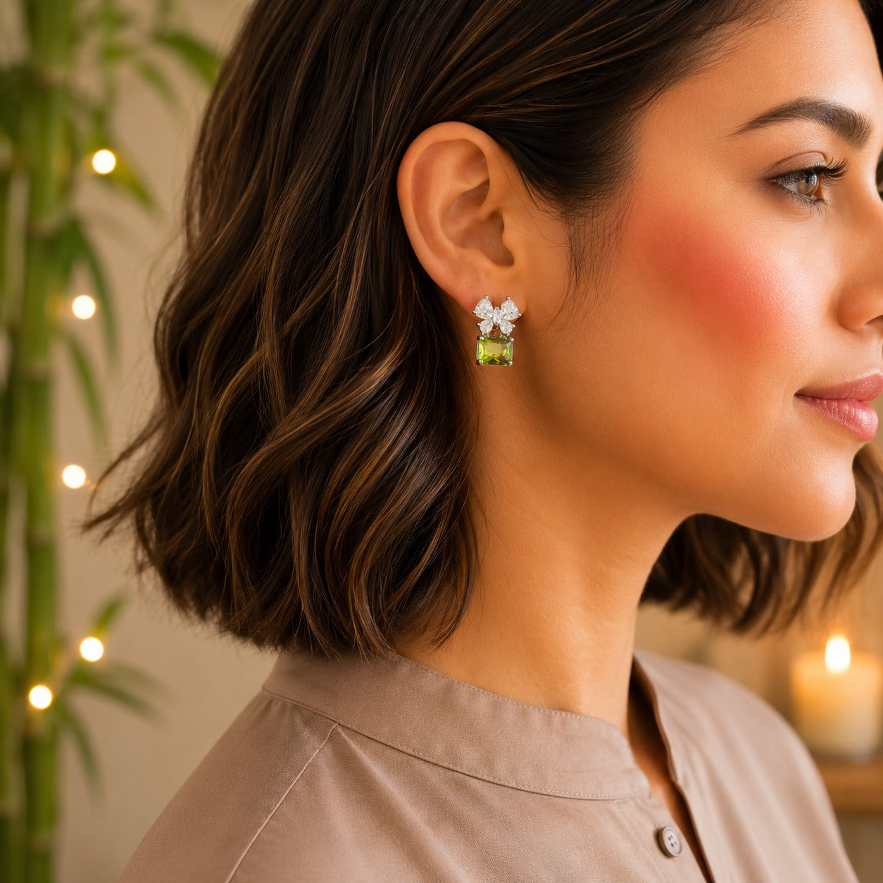 Model wearing floral crystal stud earrings with a champagne emerald-cut gemstone drop.