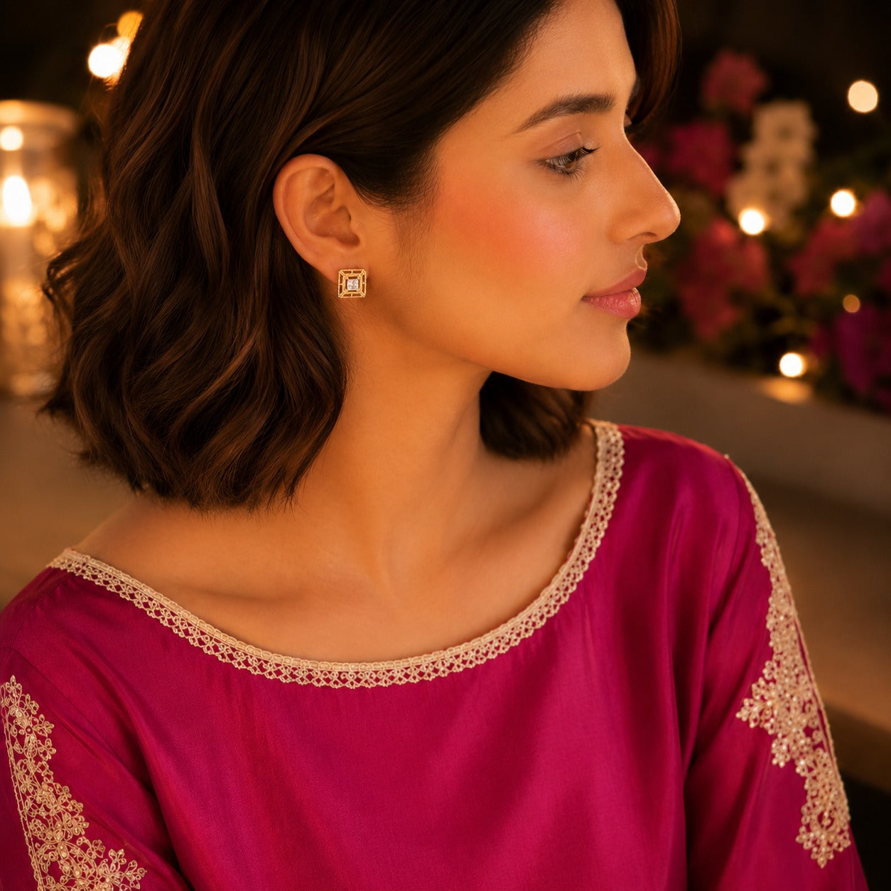 Woman wearing  gold square halo crystal stud earrings in a side-profile portrait with a premium festive background.