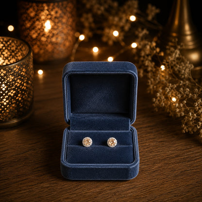 Round halo crystal stud earrings with a faceted  champagne center stone displayed in a premium navy velvet jewellery box.
