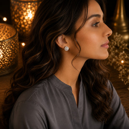 Model wearing round halo crystal stud earrings with a sparkling clear center stone and crystal border in a side-profile portrait.