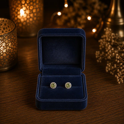 Round halo crystal stud earrings with a faceted  lime green center stone displayed in a premium navy velvet jewellery box.