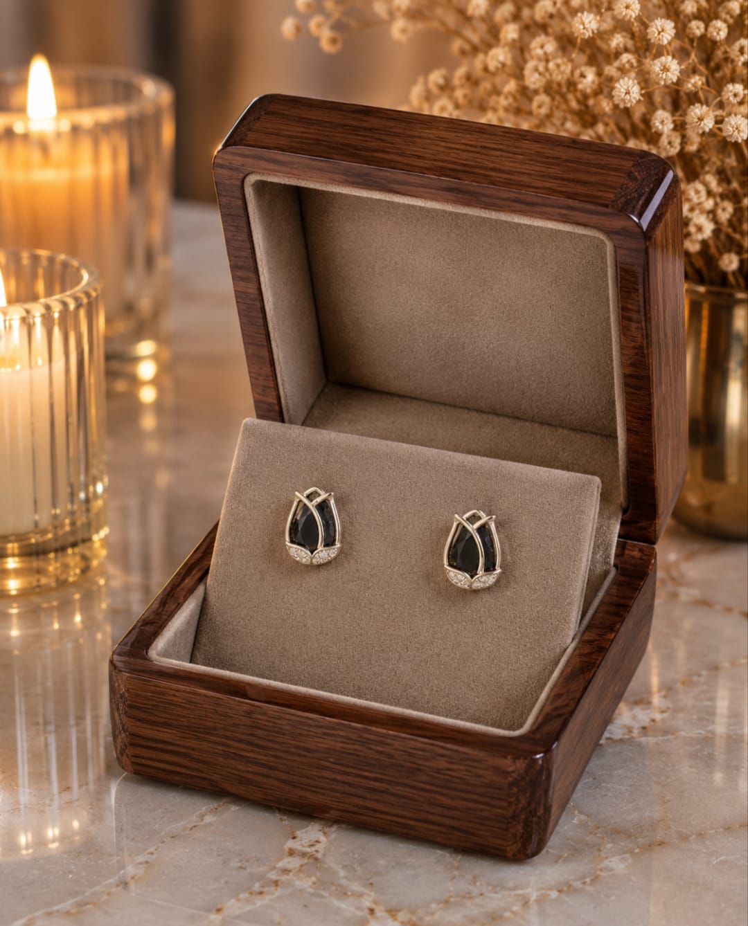 Tulip  black crystal stud earrings displayed in a premium velvet jewellery box with luxury wooden finish, candlelight ambience and dried floral décor