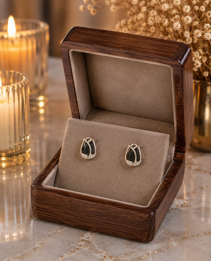 Tulip  black crystal stud earrings displayed in a premium velvet jewellery box with luxury wooden finish, candlelight ambience and dried floral décor