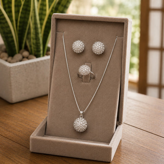 Silver crystal pendant necklace, matching stud earrings and coordinating crystal ring displayed in a premium taupe velvet jewellery gift box.