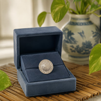 Silver sunburst statement ring presented inside a premium navy velvet jewellery box in an elegant luxury display.