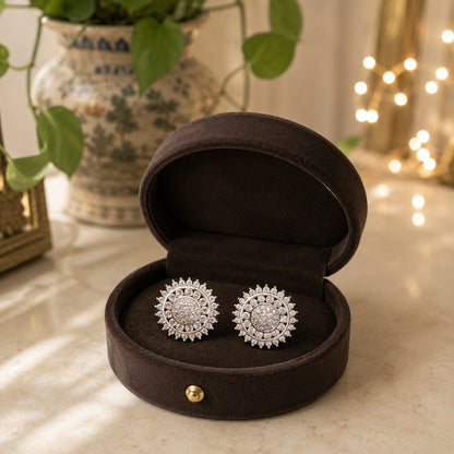 Daybreak silver crystal stud earrings featuring a pavé centre and radiant sunburst circular design displayed in a premium dark velvet jewellery box by TIAS Collection.