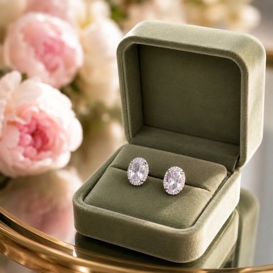 Oval halo crystal stud earrings in a sage green velvet jewellery box
