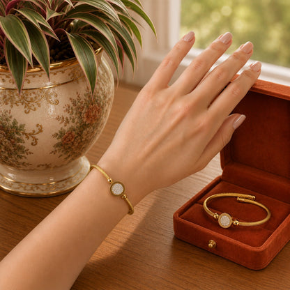 Model wearing a gold  twisted cable bracelet with a crystal pavé centerpiece on the wrist in a warm natural daylight setting.