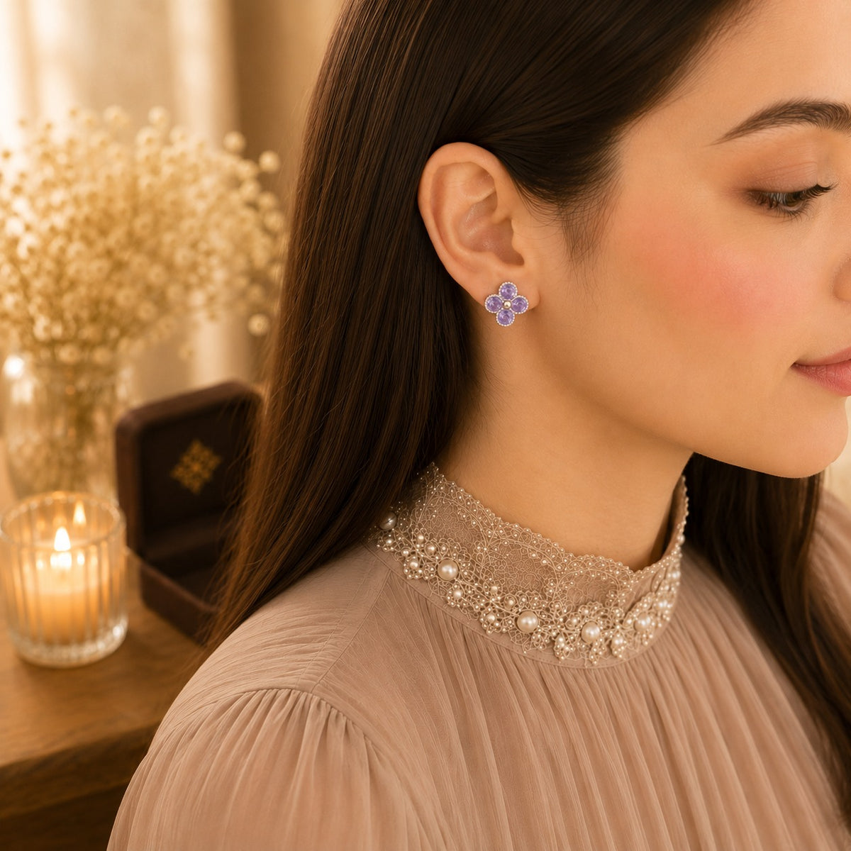 Model wearing silver lavender crystal floral stud earrings in a soft side-profile portrait with a pearl-detailed high-neck outfit