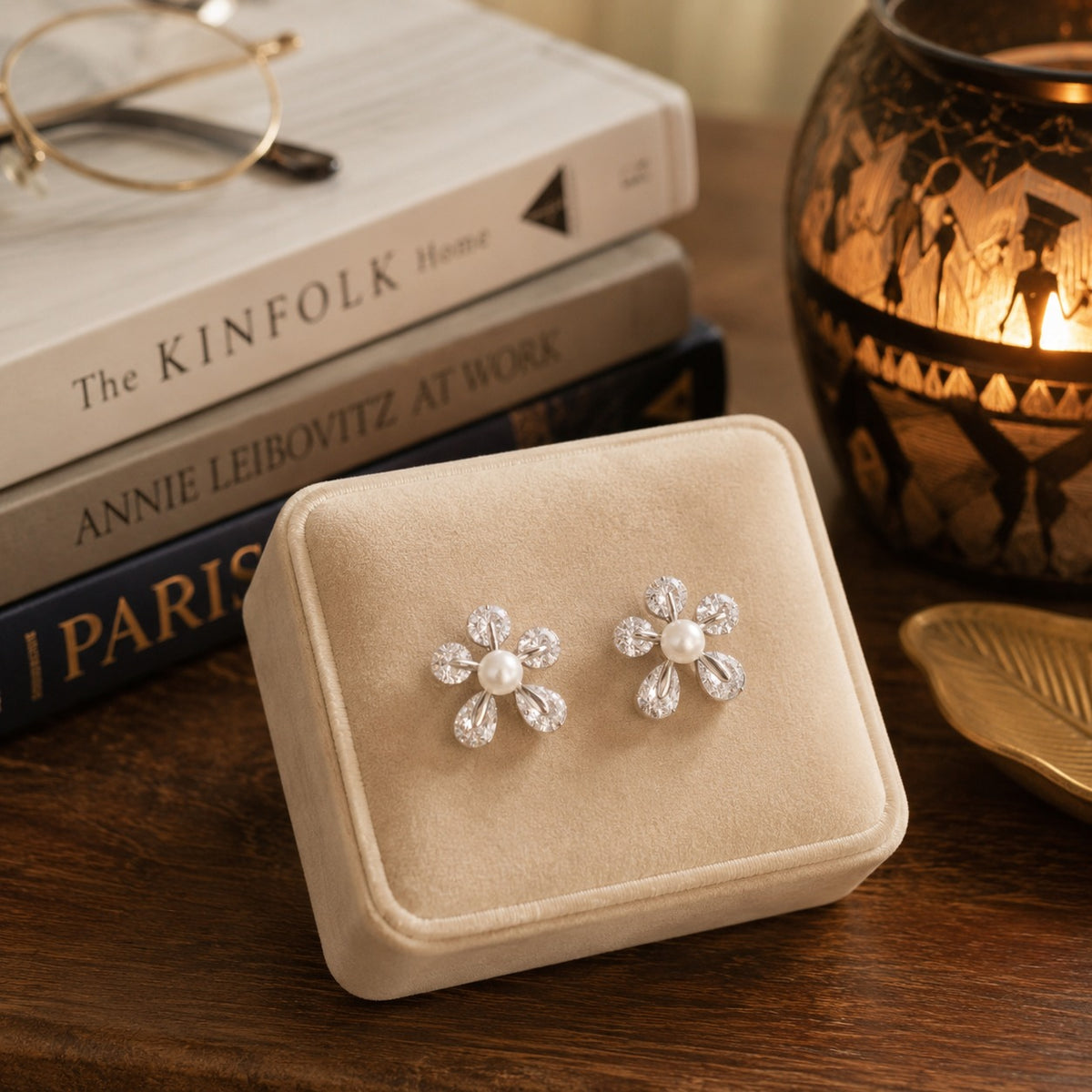 Floral pearl and clear zircon stud earrings in silver-tone finish displayed in a premium beige velvet jewelry box