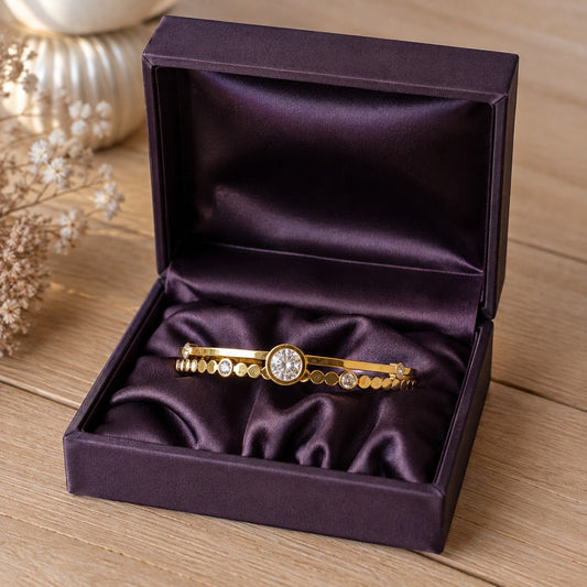 Gold crystal bracelet displayed inside a premium deep purple satin jewelry box