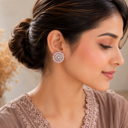 Close-up side profile highlighting rosé floral crystal stud earrings with blush pink stones and radiant circular detailing.