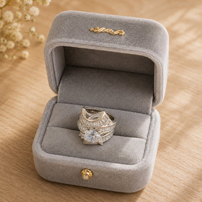 S925 sterling silver statement ring with a round-cut center stone displayed in a premium light grey velvet ring b