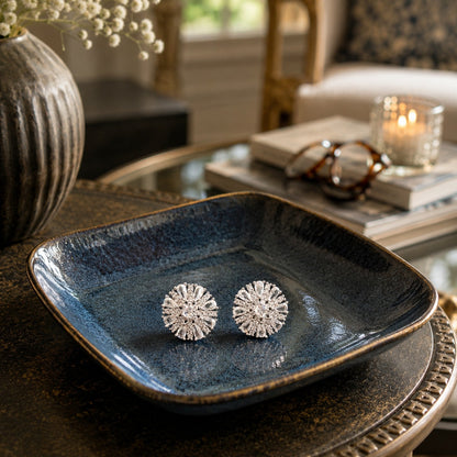 Silver  crystal floral stud earrings displayed on a premium ceramic tray in a luxury home setting.