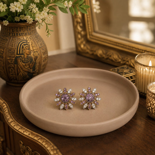 Lavender floral crystal stud earrings displayed on a premium neutral display tray with warm luxury décor