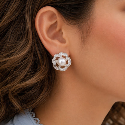 Silver pearl floral stud earring worn on model, close-up view